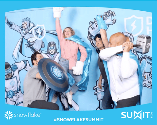 Alation’s team taking action hero pictures at Snowflake Summit 2022 picture booth