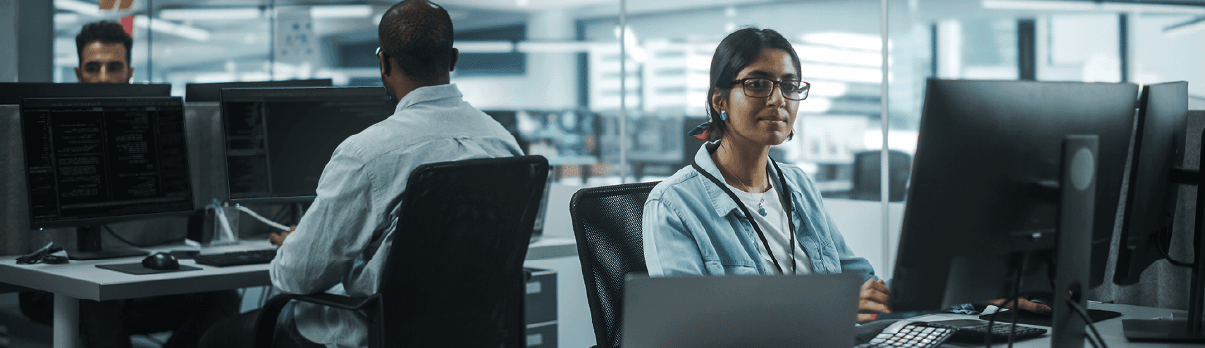 Female engineer smiling as she works in an opened office plan