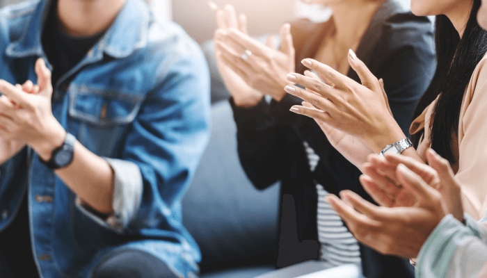 Alation Blog Image: People clapping to showcase the celebration for Alation winning three new TrustRadius awards.