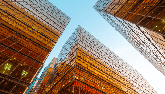 Alation Blog Image: A unique perspective of three towering buildings is captured from a lower angle, as if gazing upward.