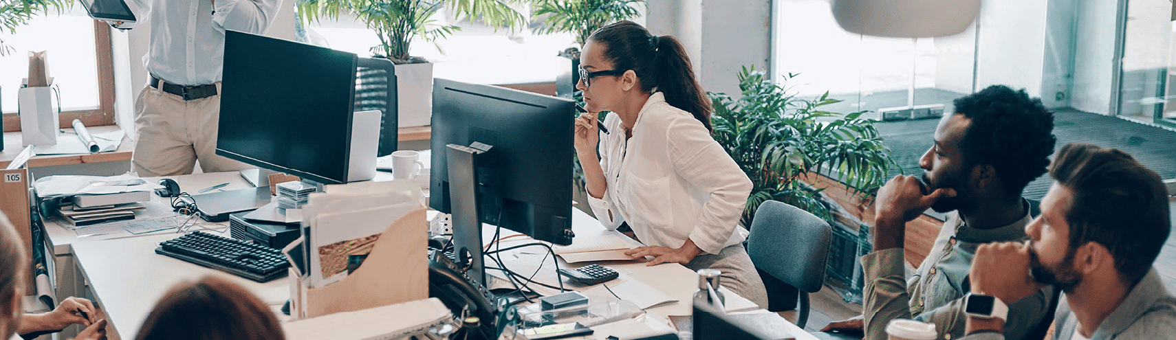 Group of young individuals in an office setting researching how to be data driven