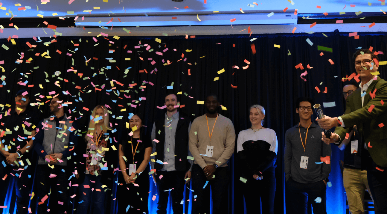 Alation blog image: Confetti flying on a stage with several people