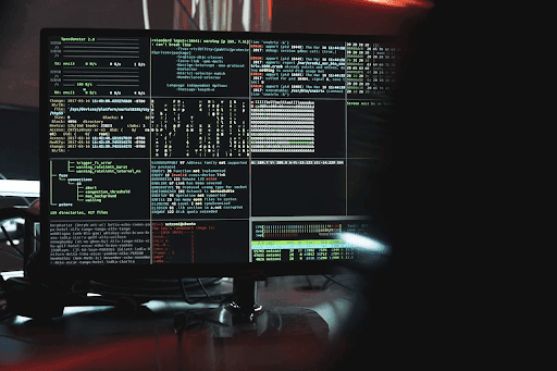 Desktop monitor showcasing data-sharing platforms through various code snippets.