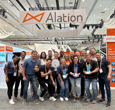 Alationauts gathered together in front of Alation’s booth at Snowflake Summit 2023