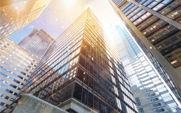 A view looking up at skyscrapers from the street