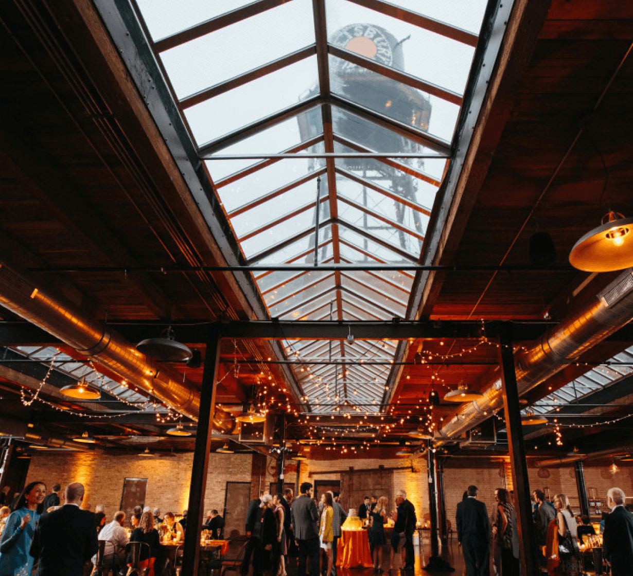 Rooftop bar overlooking Chicago skyline at dusk, with illuminated skyscrapers and the Chicago River with its bridges.