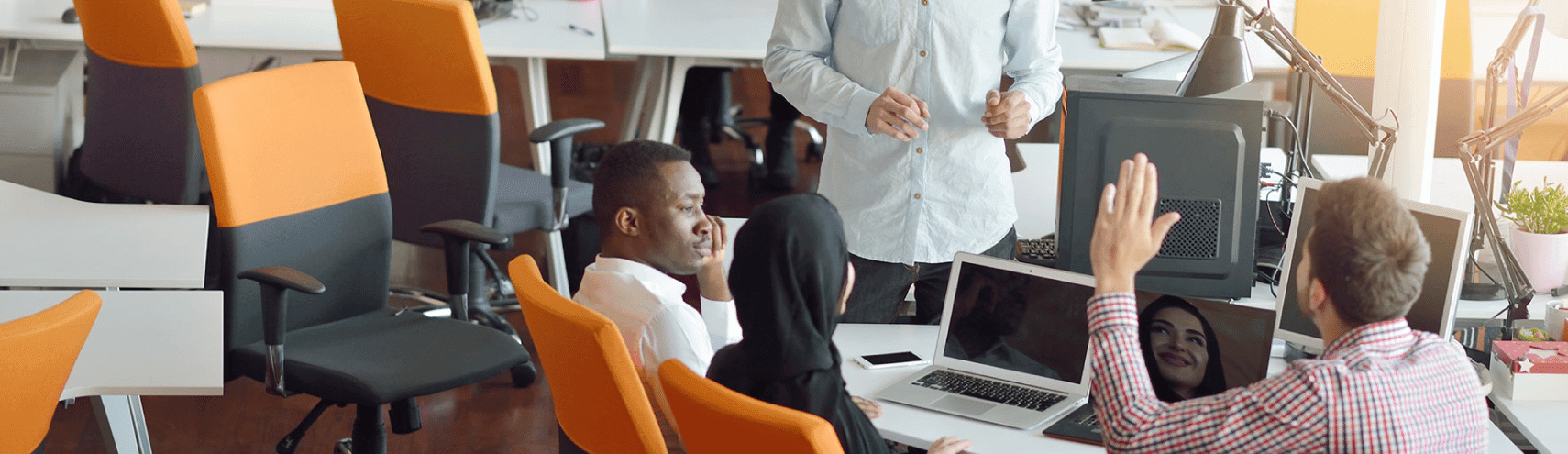 A diverse group of individuals in an office setting having a conversation