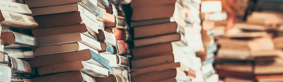 Alation image: stack of books piled together to represent data curation