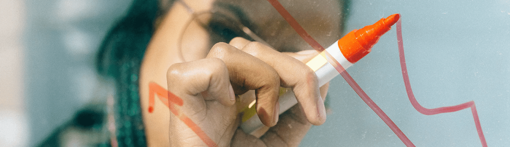 Business woman writing on a whiteboard