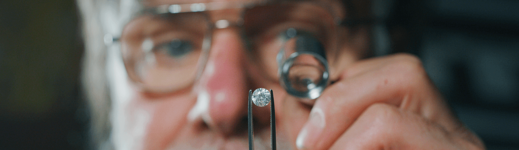 An older man looking into a diamond as a representation of analyzing data quality