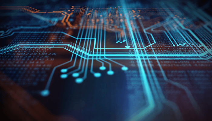 Alation Blog Image: A close-up image of a computer chip featuring intricate blue code lines.