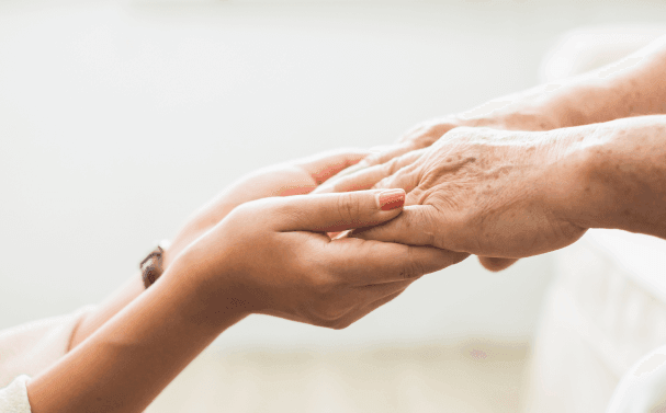 Two people holding hands
