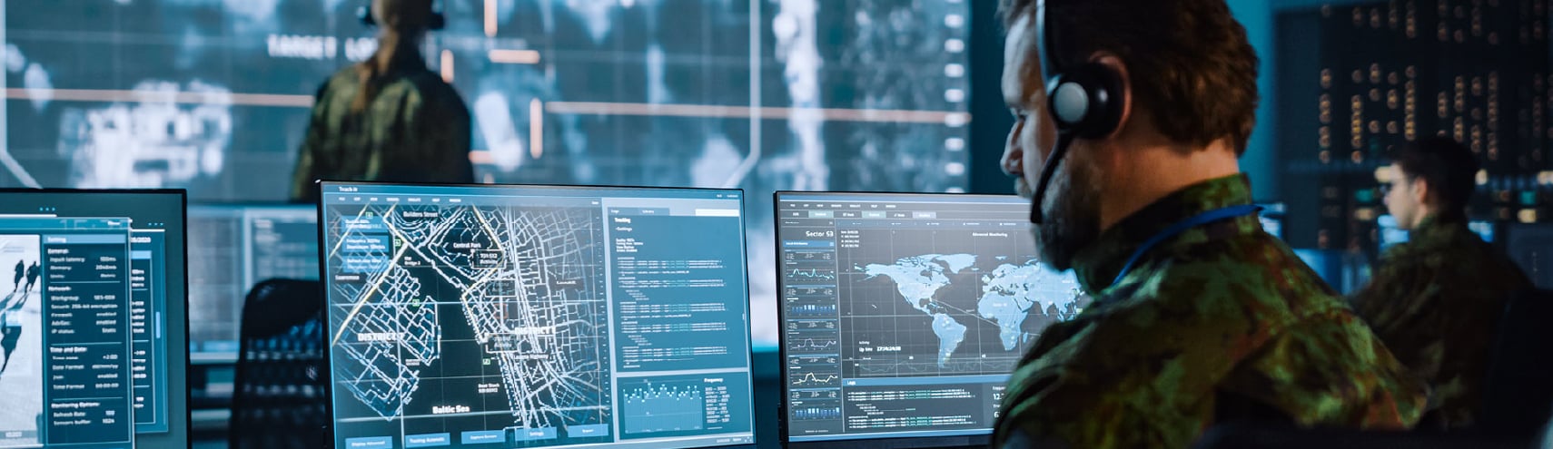 UK defence sector soldier ensuring compliance while inputing data into his computer in his workspace.