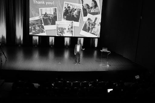 Captivating black and white image of Satyen Sangani, Alation's CEO, delivering a compelling presentation at revAlation.