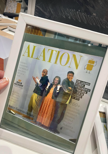 Alation’s CEO (Satyen Sangani), Alation’s CPO (Joy Wolken), and Alation’s CTO (Junaid Saiyed) posing behind an Alation newspaper cutout.